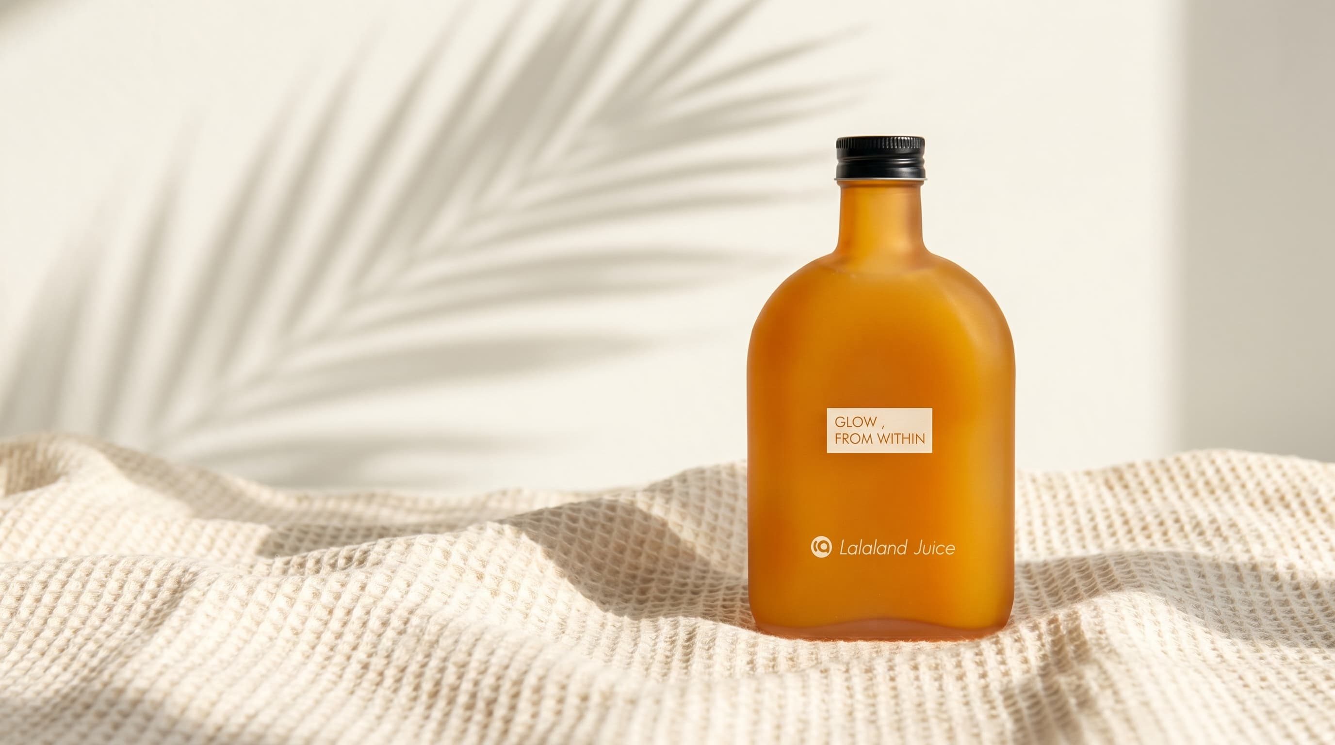 A chilled Lalaland flask on rumpled waffle linen in morning light